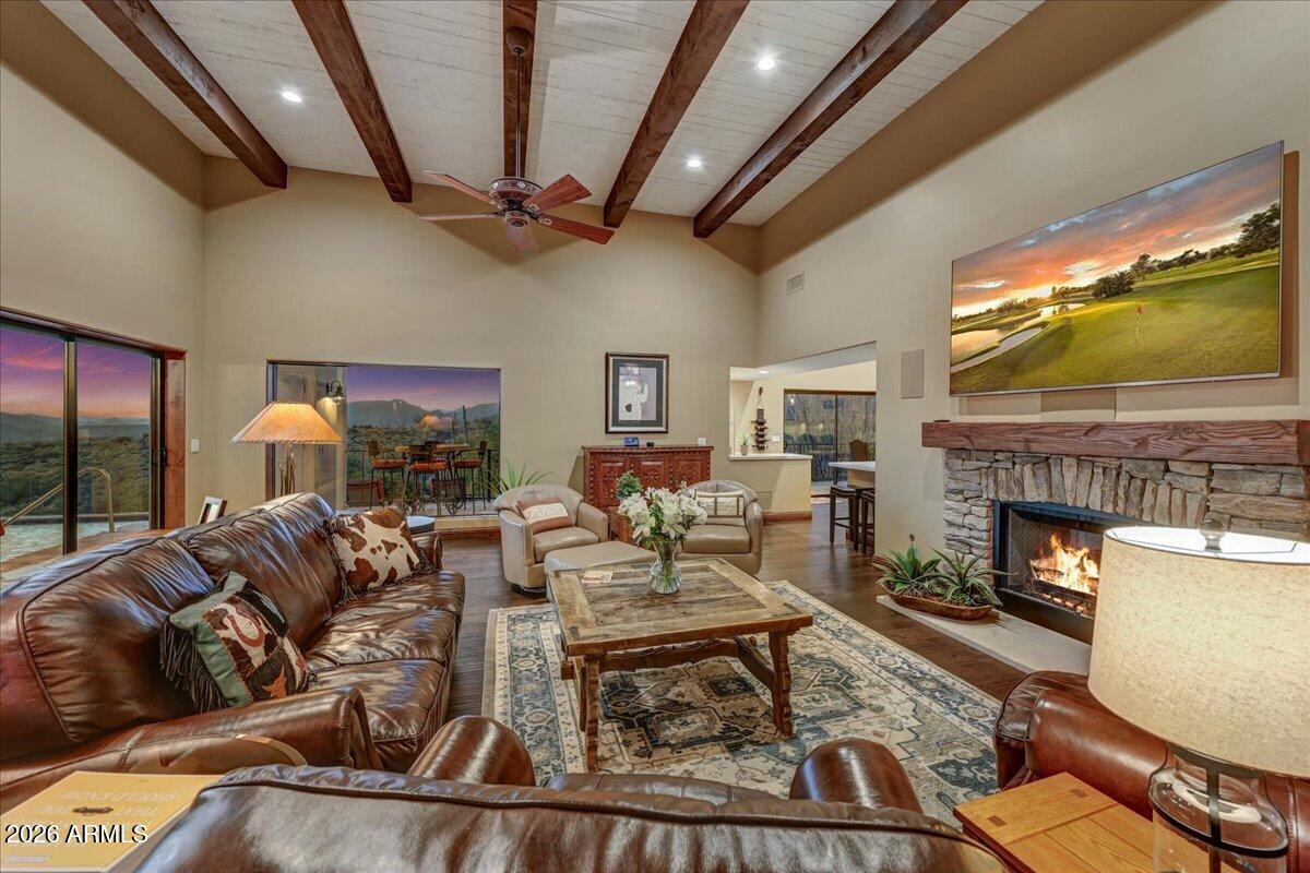 8343 East Spanish Boot Road Carefree, AZ 85377 - Photo 11 of 71 a living room with furniture a fireplace and a flat screen tv