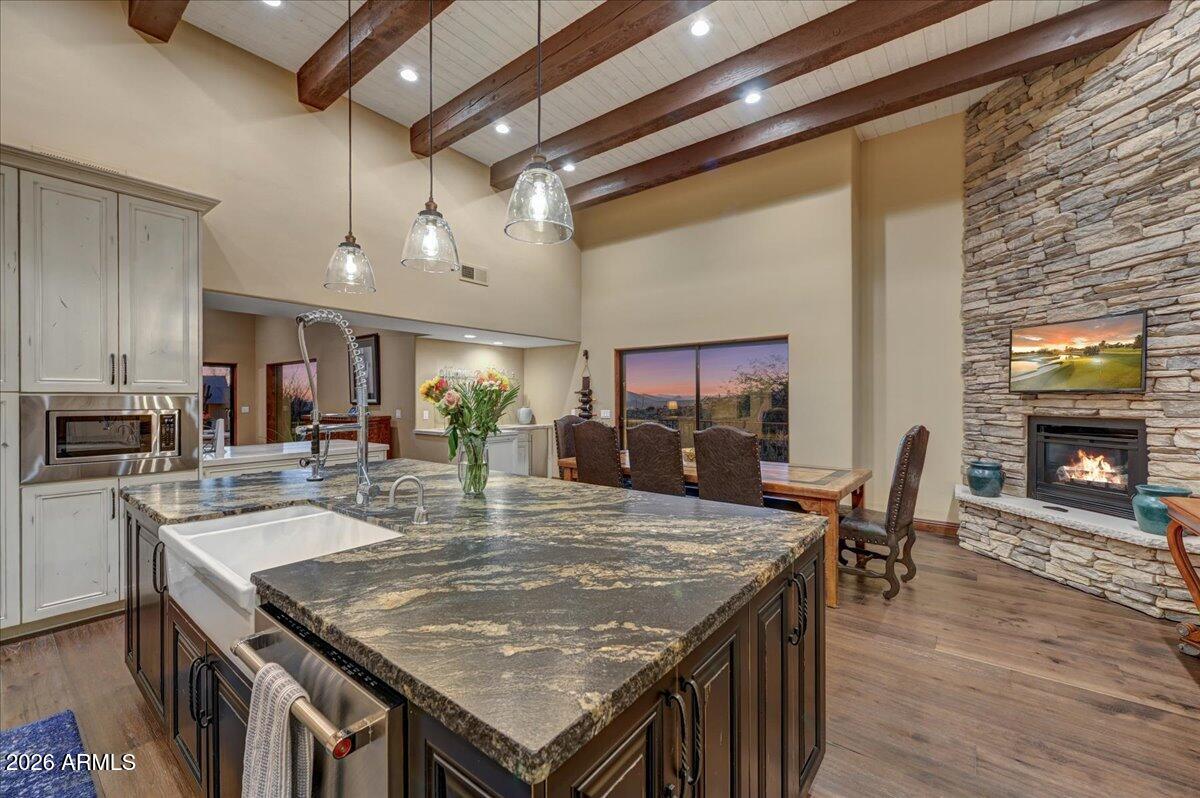 8343 East Spanish Boot Road Carefree, AZ 85377 - Photo 17 of 71 a kitchen with a table chairs and wooden floor