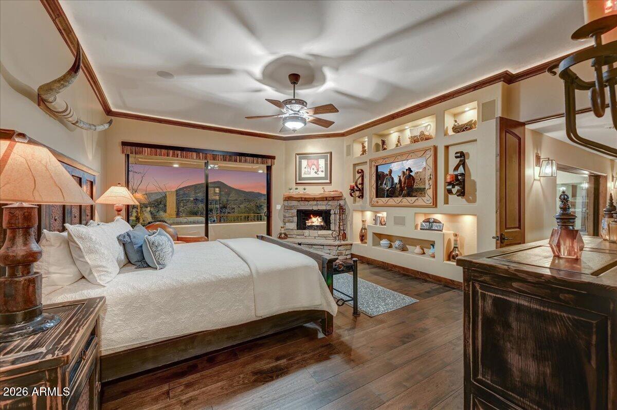 8343 East Spanish Boot Road Carefree, AZ 85377 - Photo 27 of 71 a bedroom with a large bed a flat tv screen and a dresser