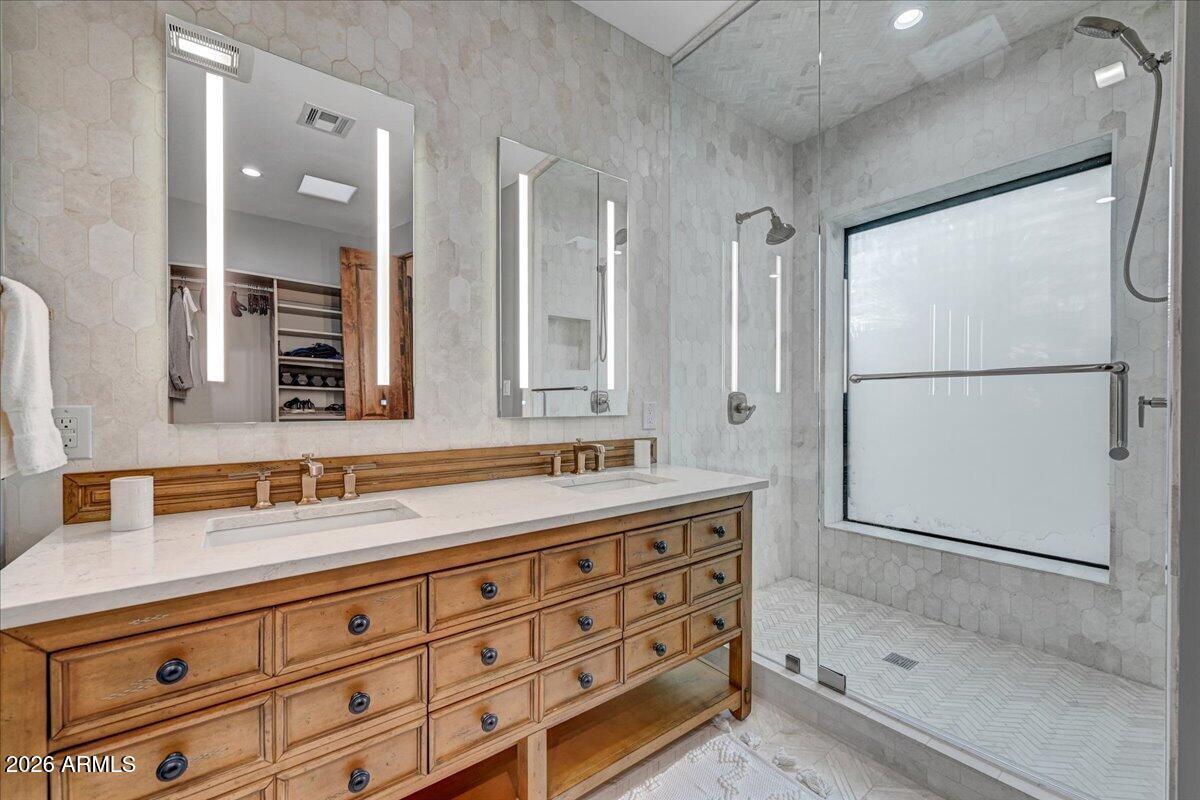 8343 East Spanish Boot Road Carefree, AZ 85377 - Photo 35 of 71 a bathroom with a shower sink and mirror