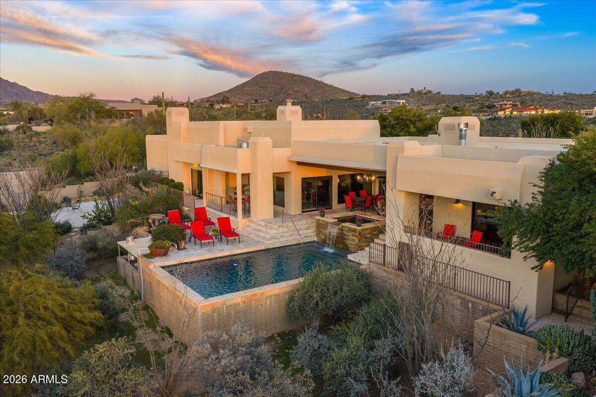 8343 East Spanish Boot Road Carefree, AZ 85377 - Photo 56 of 71 a view of a white house with swimming pool and mountains in the background