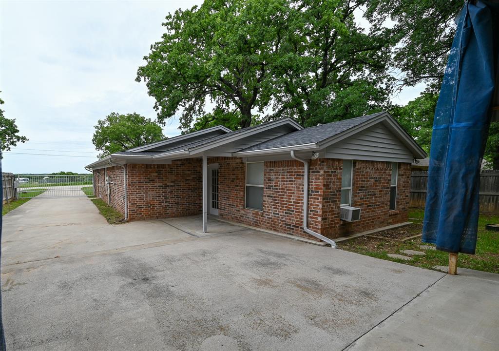 3201 South Garland Street Decatur, TX 76234 - Photo 14 of 20 a view of a house with a yard and large tree