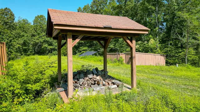 a backyard of a house with a yard and outdoor seating