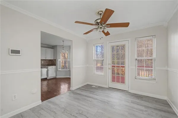 a view of empty room with wooden floor