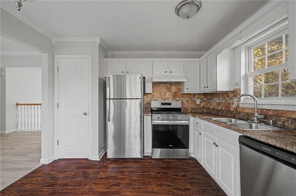 4244 Akins Ridge Lane Powder Springs, GA 30127 - Photo 16 of 37 a kitchen with stainless steel appliances granite countertop a refrigerator sink and stove