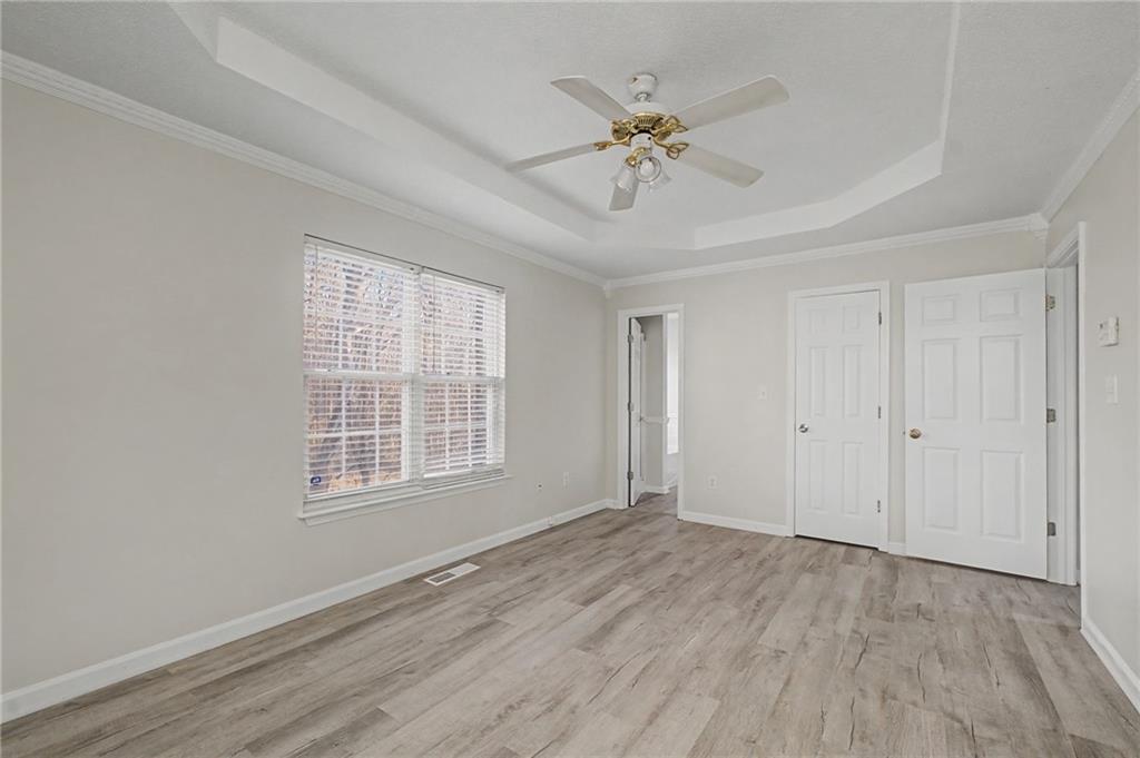4244 Akins Ridge Lane Powder Springs, GA 30127 - Photo 21 of 37 a view of an empty room with wooden floor and a window
