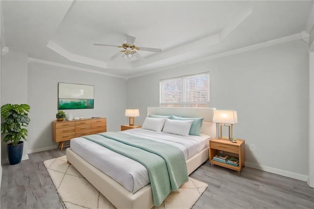 4244 Akins Ridge Lane Powder Springs, GA 30127 - Photo 22 of 37 a bedroom with a bed and a chandelier