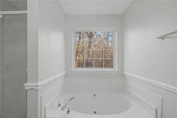 a white bath tub sitting next to a window