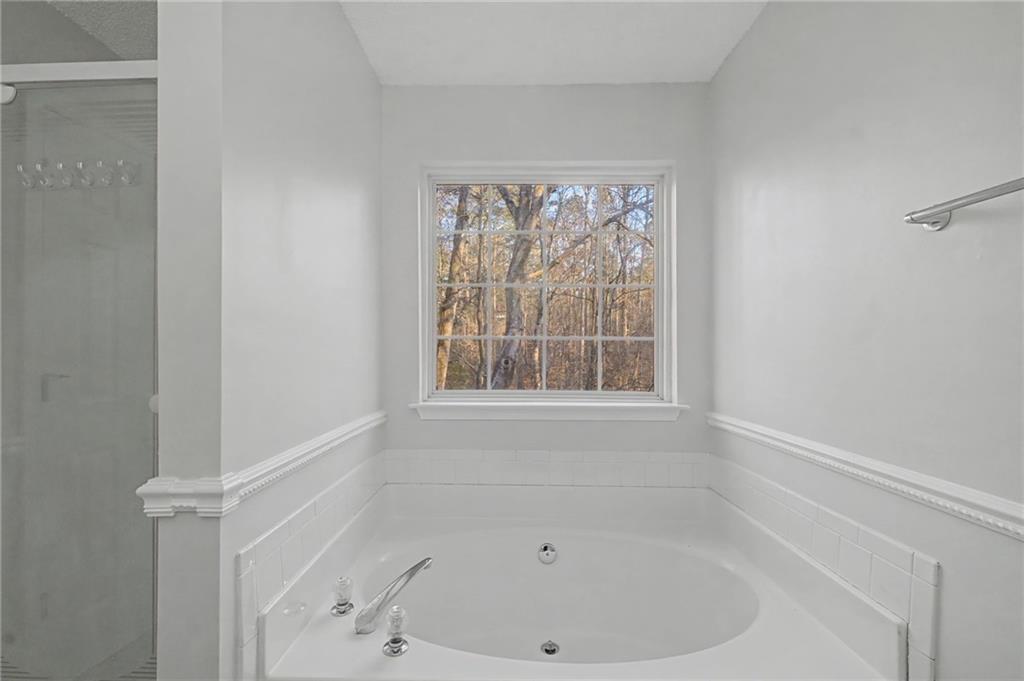 4244 Akins Ridge Lane Powder Springs, GA 30127 - Photo 25 of 37 a white bath tub sitting next to a window