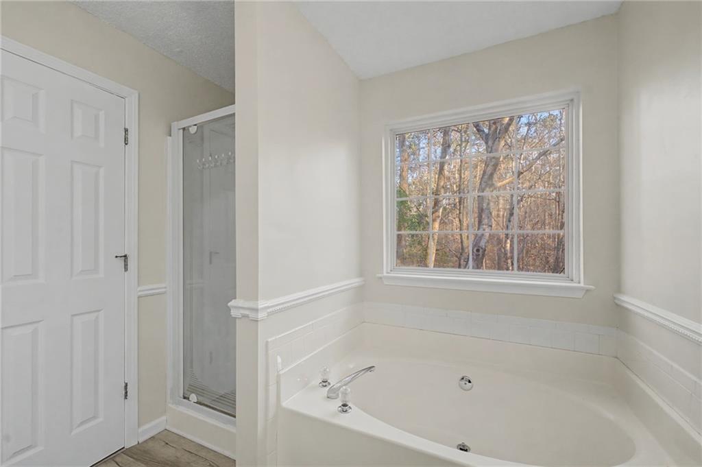 4244 Akins Ridge Lane Powder Springs, GA 30127 - Photo 26 of 37 a white bath tub sitting next to a window