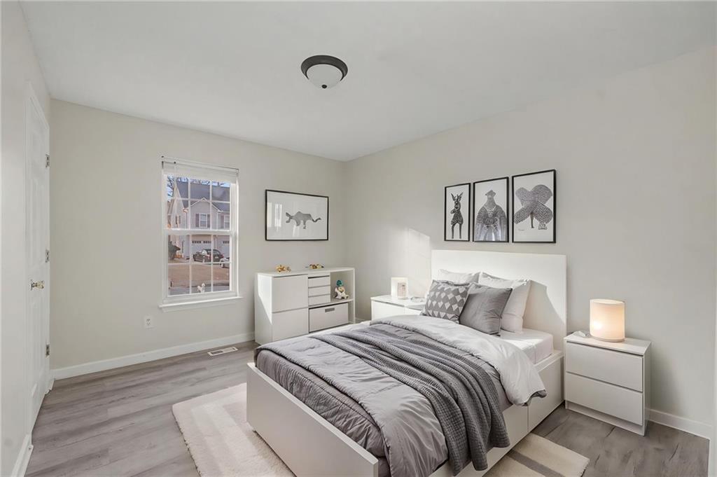 4244 Akins Ridge Lane Powder Springs, GA 30127 - Photo 29 of 37 a bedroom with a bed and a painting on the wall