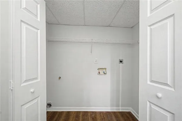 a view of a room with wooden floor and windows