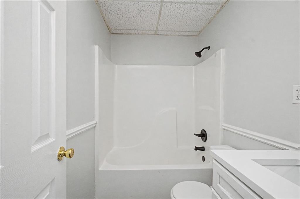 4244 Akins Ridge Lane Powder Springs, GA 30127 - Photo 33 of 37 a bathroom with a shower curtain