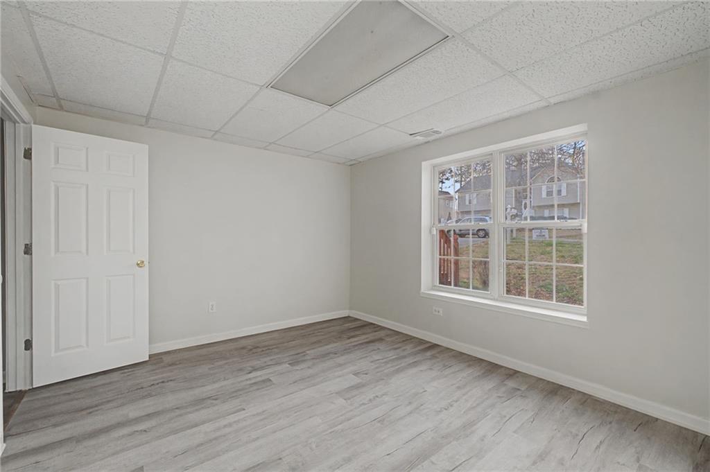 4244 Akins Ridge Lane Powder Springs, GA 30127 - Photo 35 of 37 an empty room with wooden floor and windows