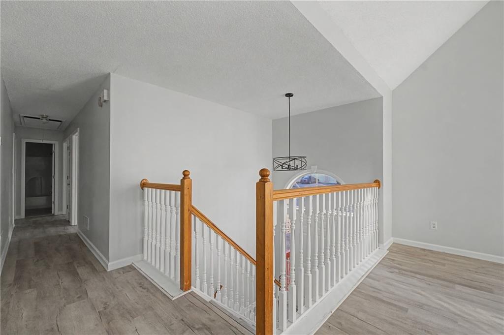 4244 Akins Ridge Lane Powder Springs, GA 30127 - Photo 4 of 37 a view of a hallway with wooden floor and stairs