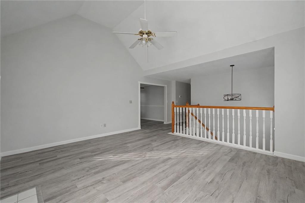 4244 Akins Ridge Lane Powder Springs, GA 30127 - Photo 7 of 37 a view of a hallway with wooden floor and a chandelier