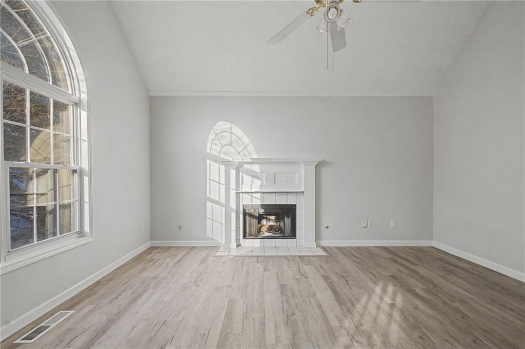 4244 Akins Ridge Lane Powder Springs, GA 30127 - Photo 9 of 37 wooden floor fireplace and windows in an empty room