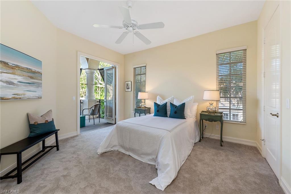 4852 West Blvd Court Naples, FL 34103 - Photo 14 of 18 a bedroom with a bed and a chandelier