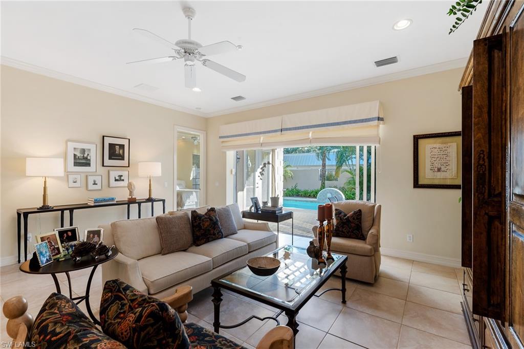 4852 West Blvd Court Naples, FL 34103 - Photo 3 of 18 a living room with furniture and a large window