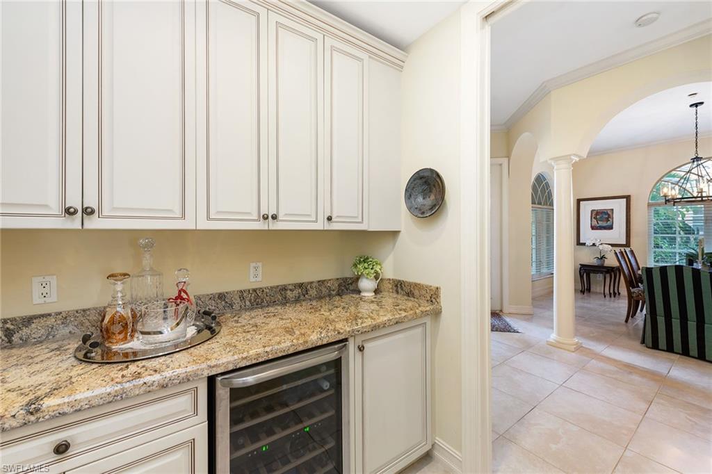 4852 West Blvd Court Naples, FL 34103 - Photo 5 of 18 a kitchen with granite countertop a sink a stove and cabinets