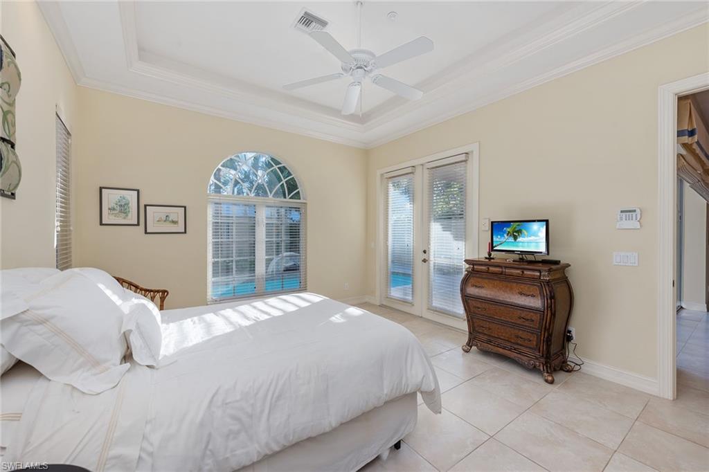 4852 West Blvd Court Naples, FL 34103 - Photo 10 of 18 a bedroom with a bed and a window