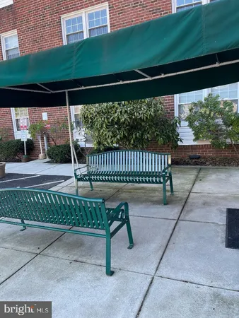 a view of a porch with a bench in patio
