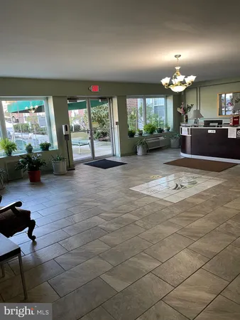 a living room with furniture a large window and a dining table