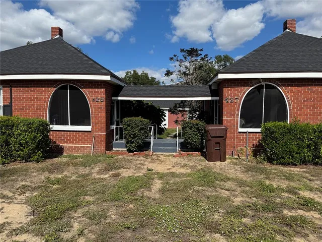 a front view of a house with garden
