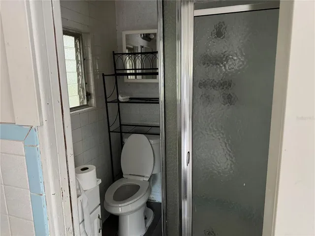 a bathroom with a toilet and a shower