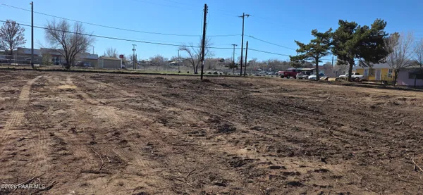 a view of a yard with wooden fence