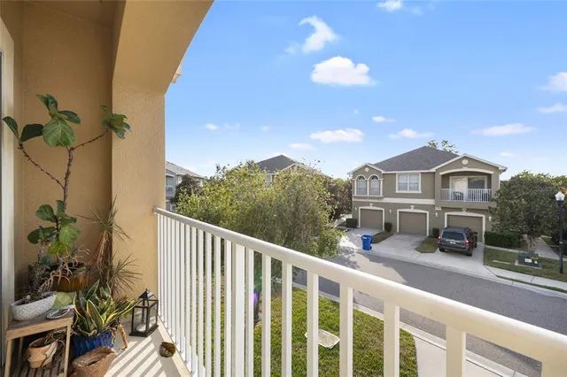 a view of a house with a balcony and wooden floor