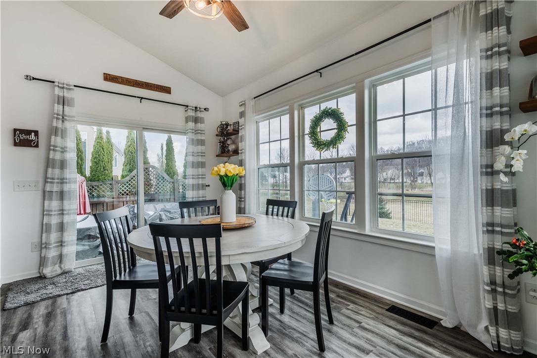 6687 List Street Northwest Canton, OH 44708 - Photo 10 of 21 Dining space with lofted ceiling, ceiling fan, and wood finished floors