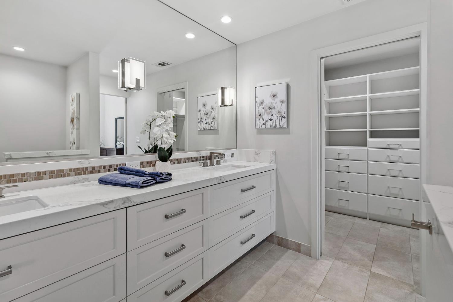 1013 Copper Lake Court Modesto, CA 95355 - Photo 23 of 66 a bathroom with a shower sink and mirror