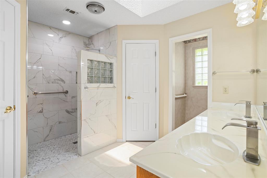 5522 Wedgefield Road Granbury, TX 76049 - Photo 16 of 22 a bathroom with a sink tub and shower