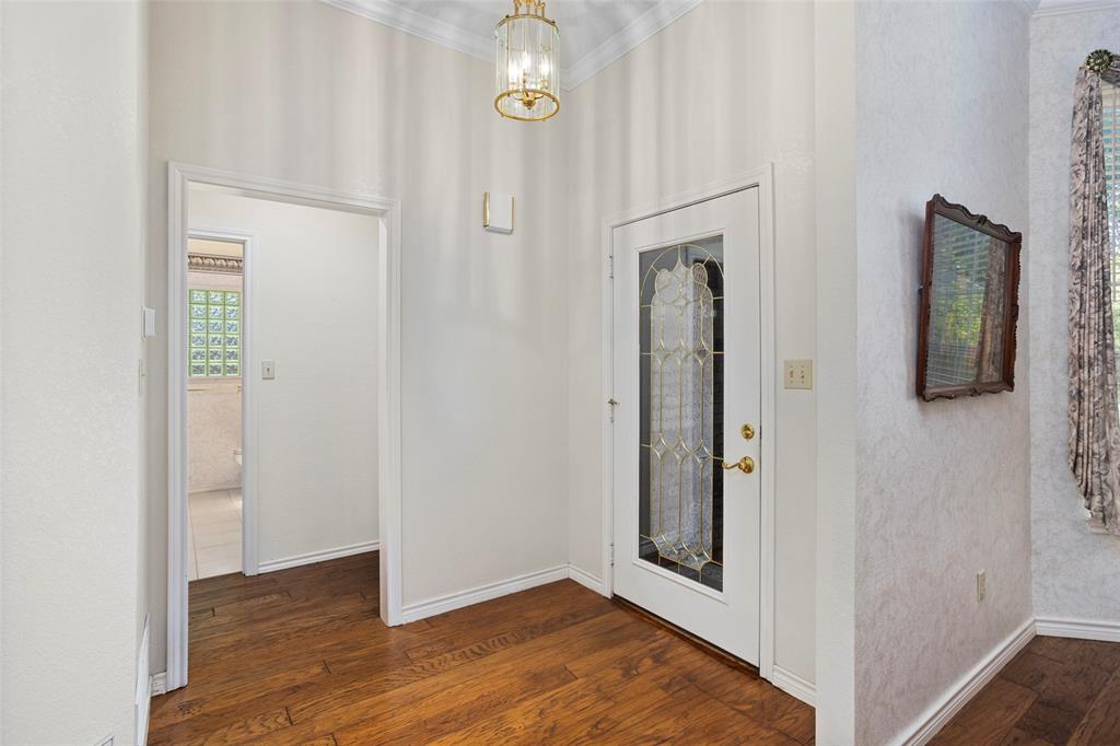 5522 Wedgefield Road Granbury, TX 76049 - Photo 3 of 22 a view of a hallway with wooden floor and entryway