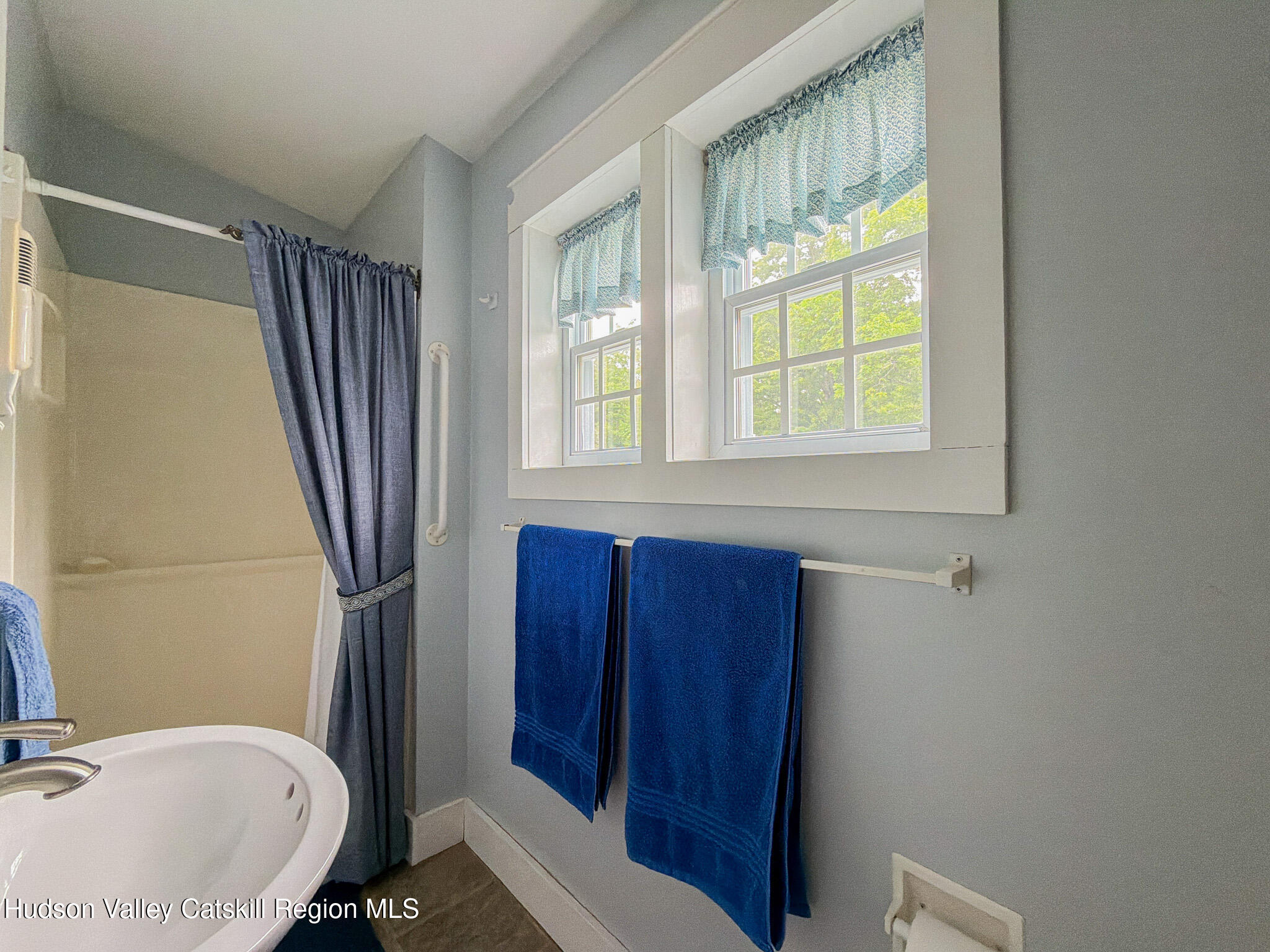 221 Camp Medusa Road Rensselaerville, NY 12120 - Photo 20 of 57 a bathroom with a sink a toilet a mirror and tub