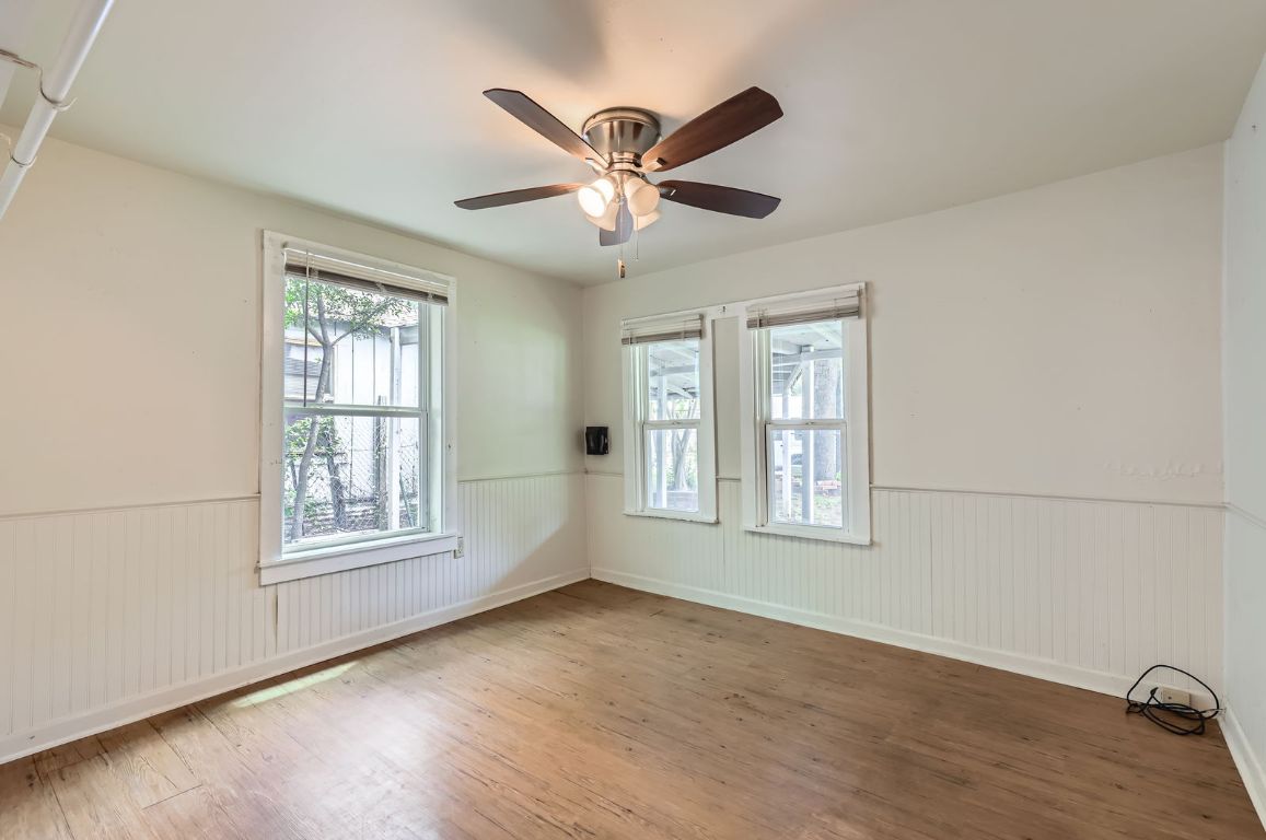 1313 Perez Street Austin, TX 78721 - Photo 4 of 8 a view of an empty room with wooden floor and a window