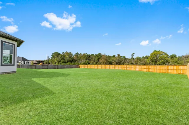 a view of a house with a yard and sitting area