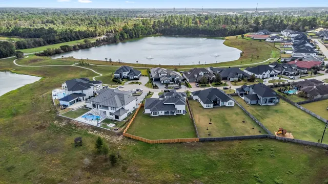 a view of swimming pool with outdoor seating and a garden