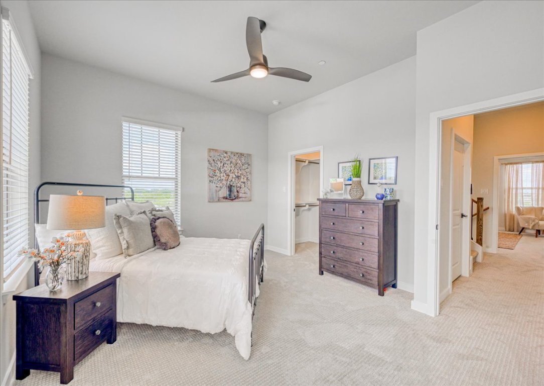 905 Pullman Street Leander, TX 78641 - Photo 16 of 31 a bedroom with a bed dresser and wooden floor