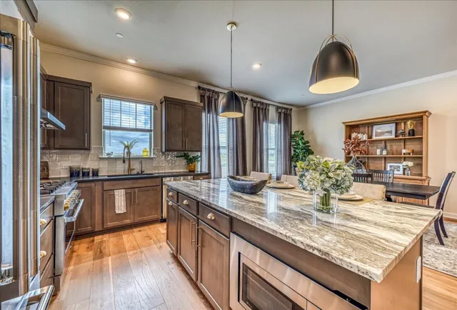 a kitchen with granite countertop a stove and cabinets