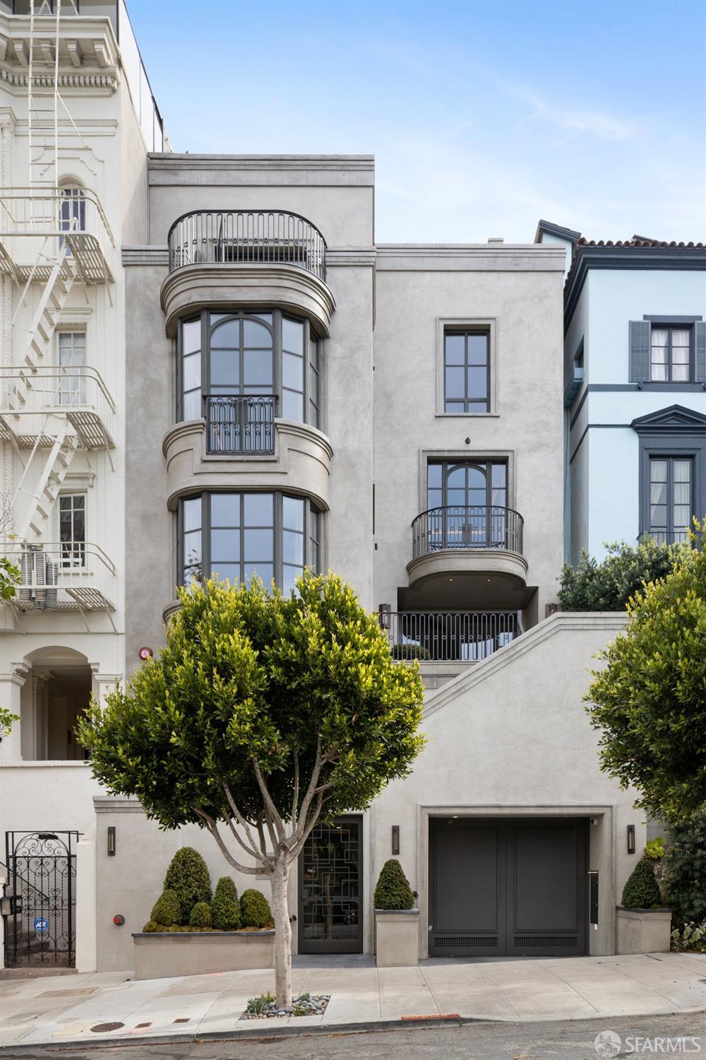 a front view of a building with potted plants