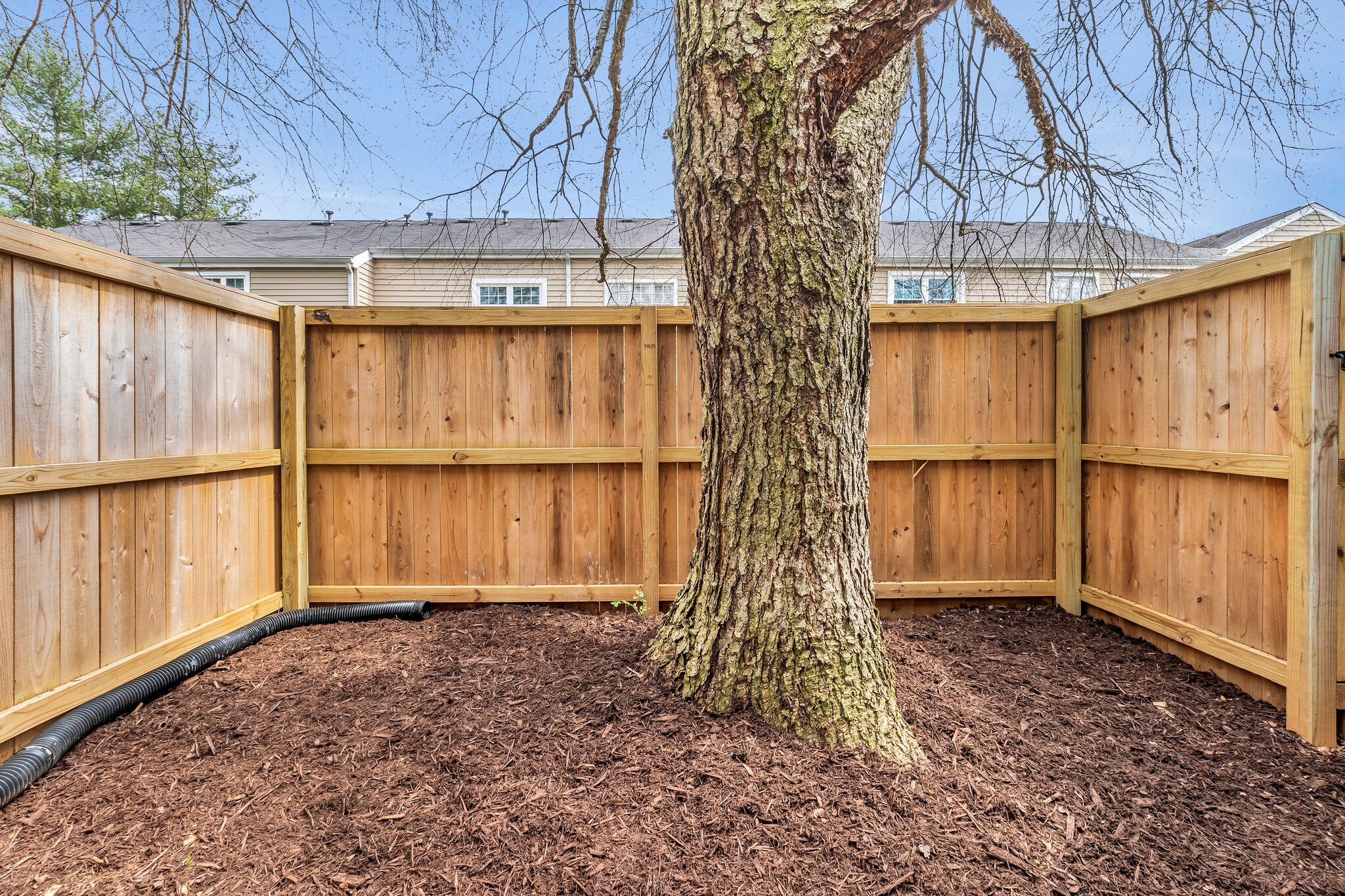 2004 Granville Road Franklin, TN 37064 - Photo 26 of 32 a backyard of a house with large tree and wooden fence