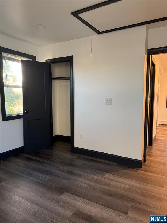 27 Emerald Street Hackensack, NJ 07601 - Photo 17 of 42 an empty room with wooden floor and windows