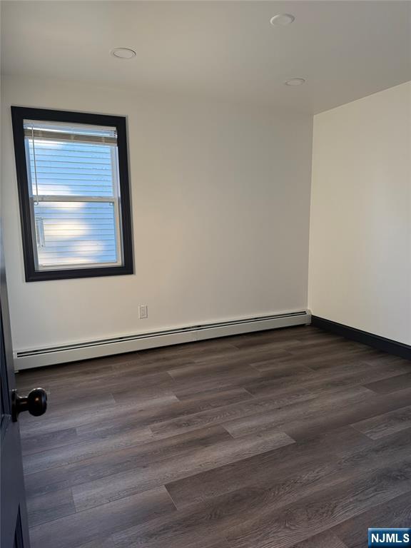 27 Emerald Street Hackensack, NJ 07601 - Photo 19 of 42 a view of an empty room with wooden floor and a window