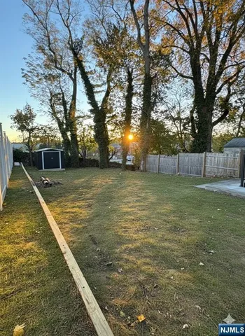 a view of a backyard with large trees