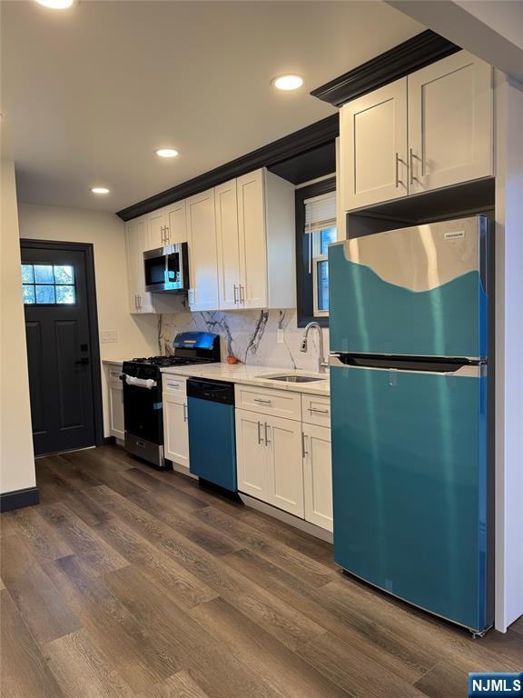 27 Emerald Street Hackensack, NJ 07601 - Photo 6 of 42 a kitchen with a sink a refrigerator and cabinets