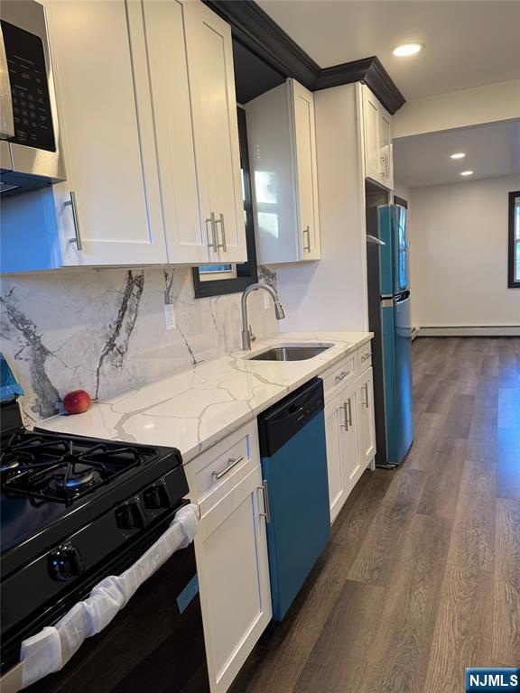 27 Emerald Street Hackensack, NJ 07601 - Photo 7 of 42 a kitchen with a sink stove and cabinets
