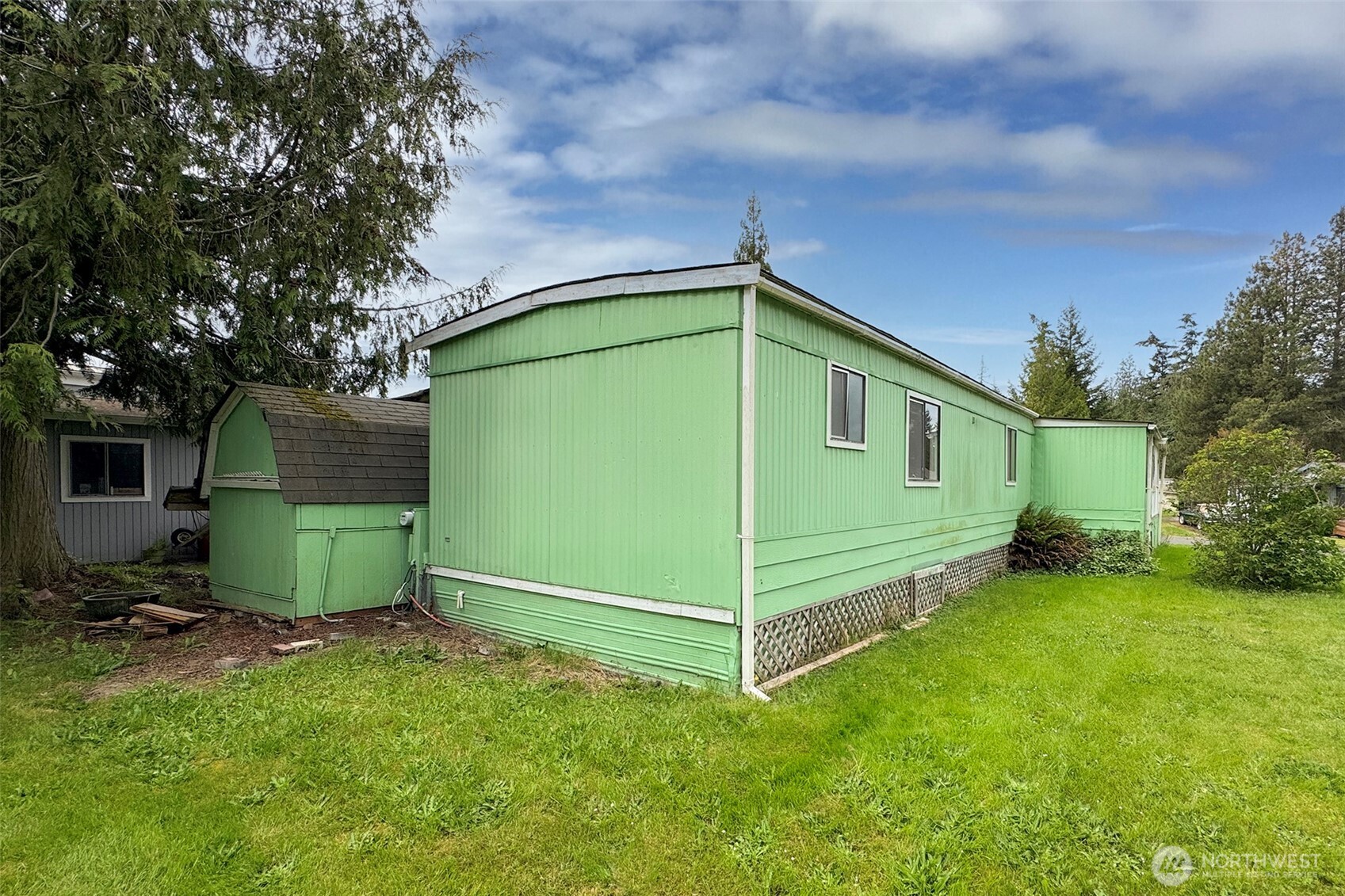90 Baywood Village Road, Unit 34 Sequim, WA 98382 - Photo 38 of 40 a green field with some trees in the background