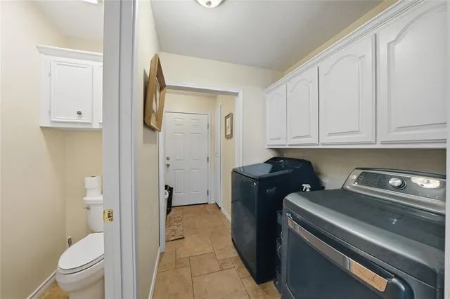 a kitchen with a refrigerator and cabinets